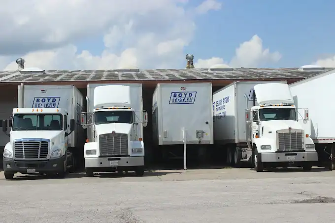 Boyd Total fleet of five delivery trucks arranged in front of company facility